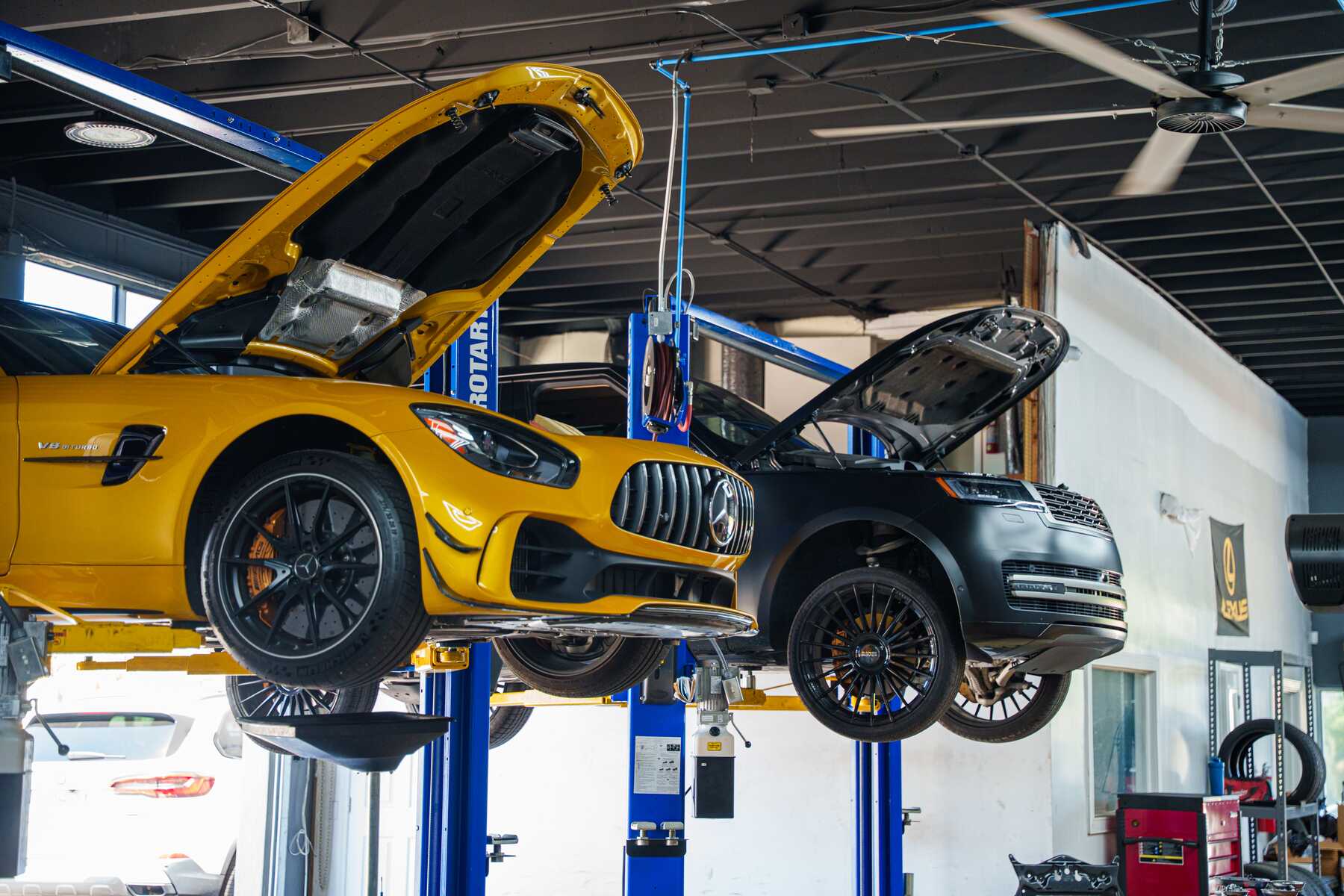A Mercedes-AMG GT with the hood open on the lift at Autobahn Auto Center