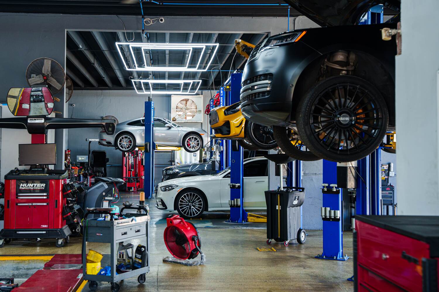 The Autobahn Auto Center service bay in Boca Raton, cars on the lifts
