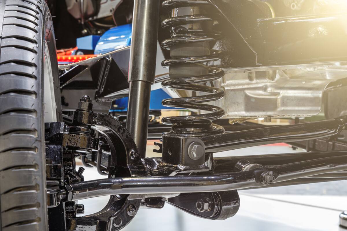 Coil spring and strut assembly under a vehicle