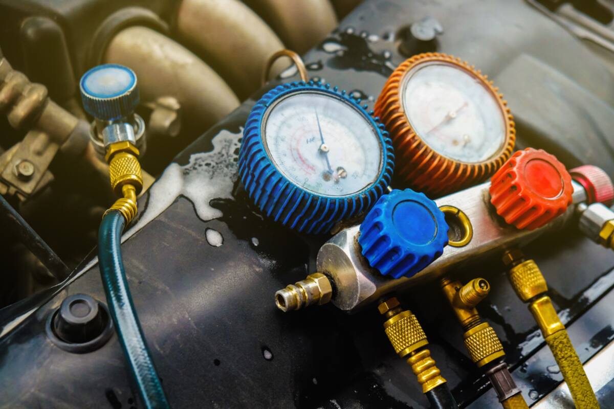 Air conditioning manifold gauges connected to a vehicle