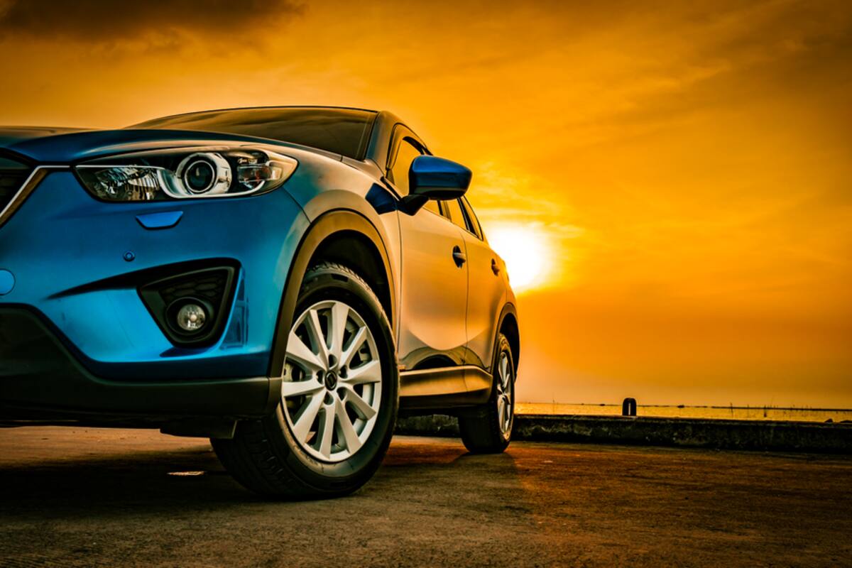 Blue SUV photographed at sunset