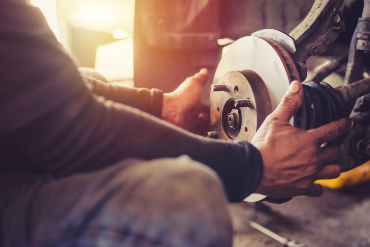 Technician's hands on a brake disc