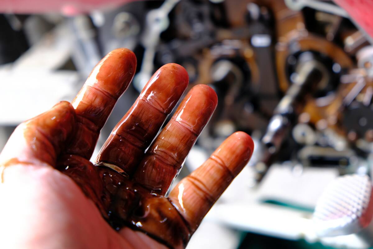 Hand covered in engine oil