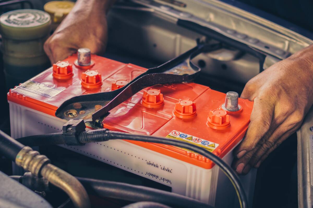 Technician connecting a car battery