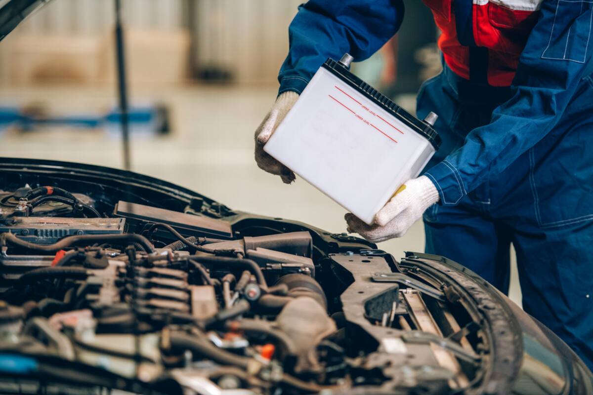 Technician inspecting an engine with a clipboard