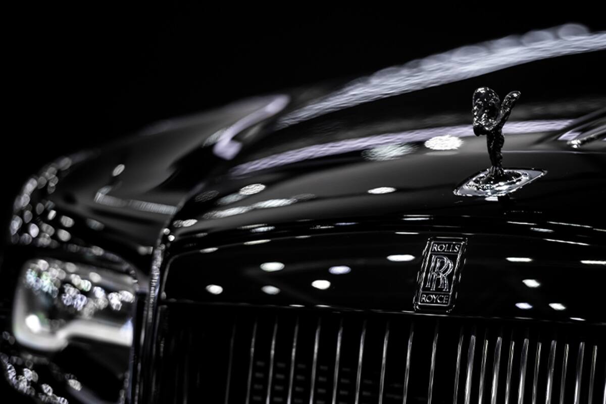 Grille and hood ornament of a black Rolls-Royce