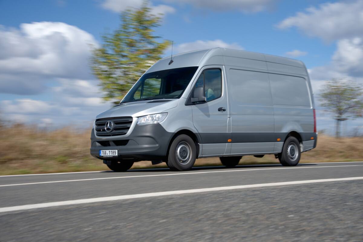 Silver Mercedes Sprinter van on the road