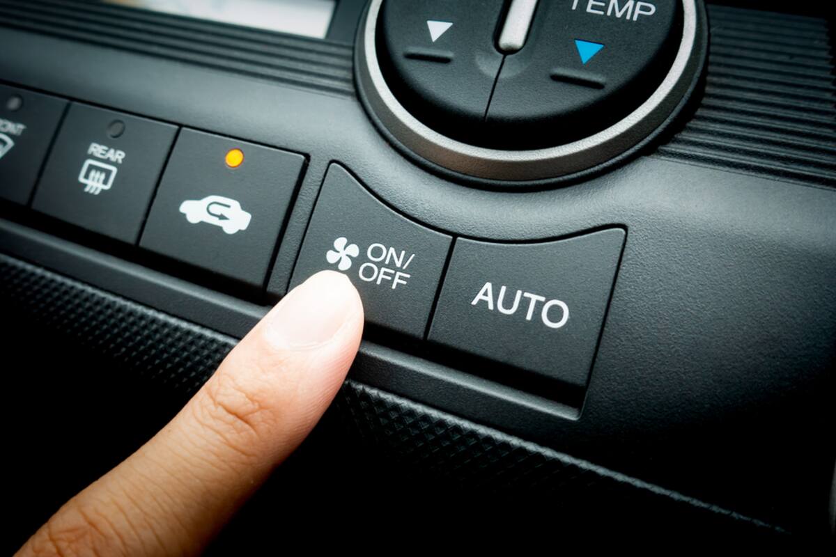 Finger pressing climate control buttons