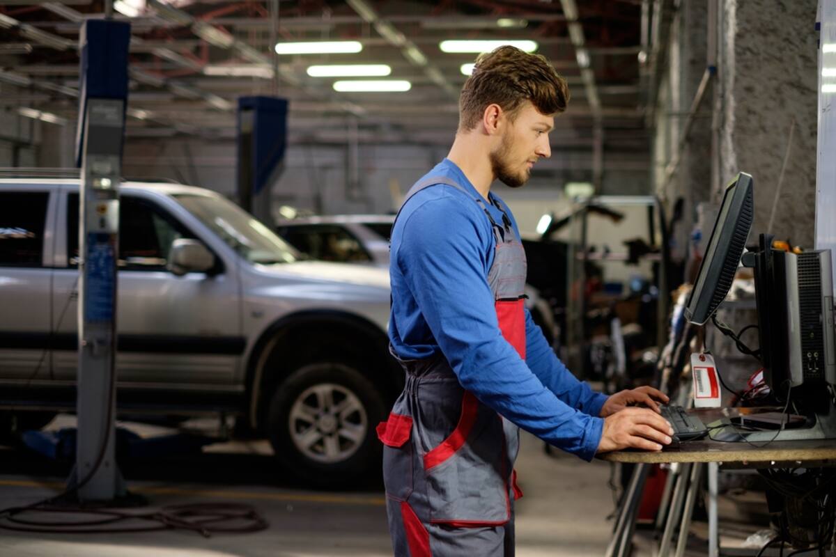 Technician at a diagnostic workstation in a workshop