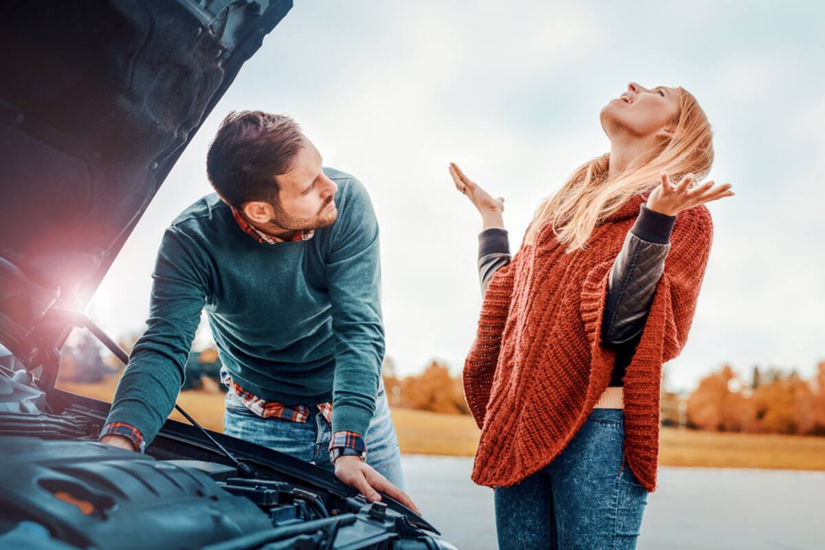 Couple beside a car with the hood raised