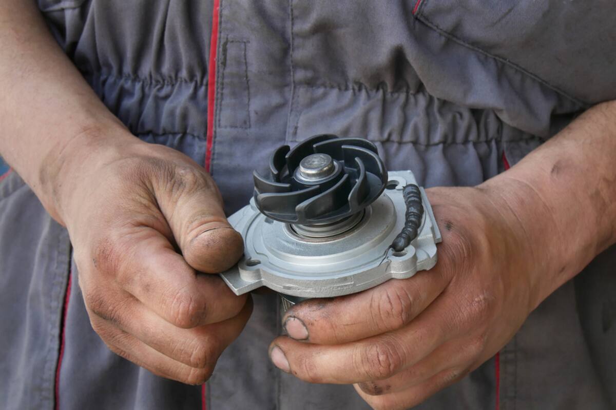 Technician holding a water pump