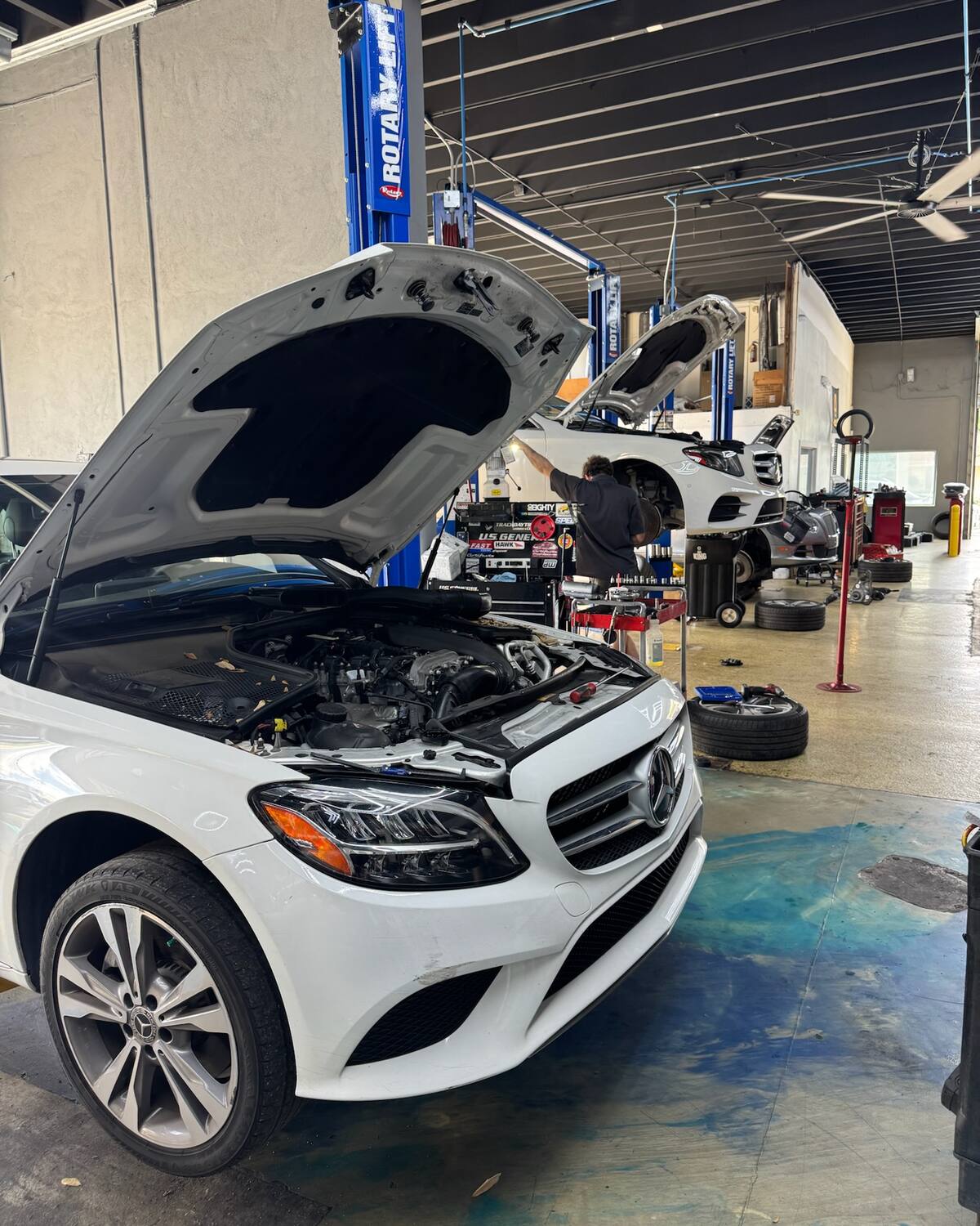 A white Mercedes-Benz C-Class with the hood open at Autobahn Auto Center