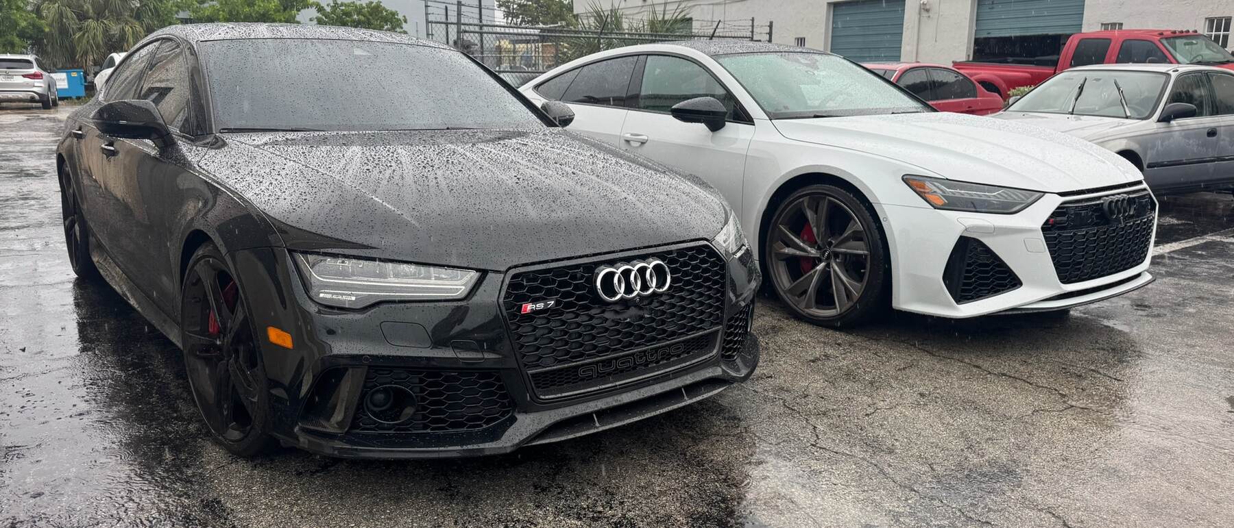 Two Audi RS models parked outside Autobahn Auto Center