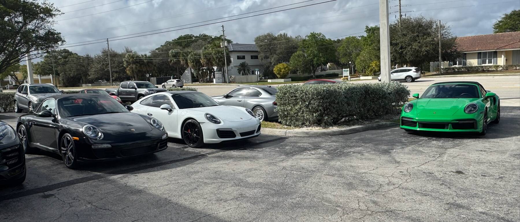 Porsche 911s parked in the lot at Autobahn Auto Center