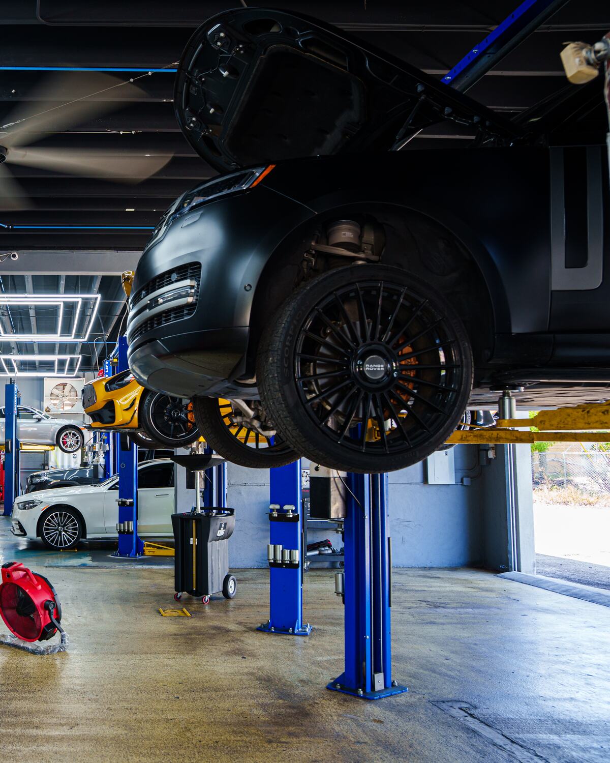 A black Range Rover raised on the lift at Autobahn Auto Center