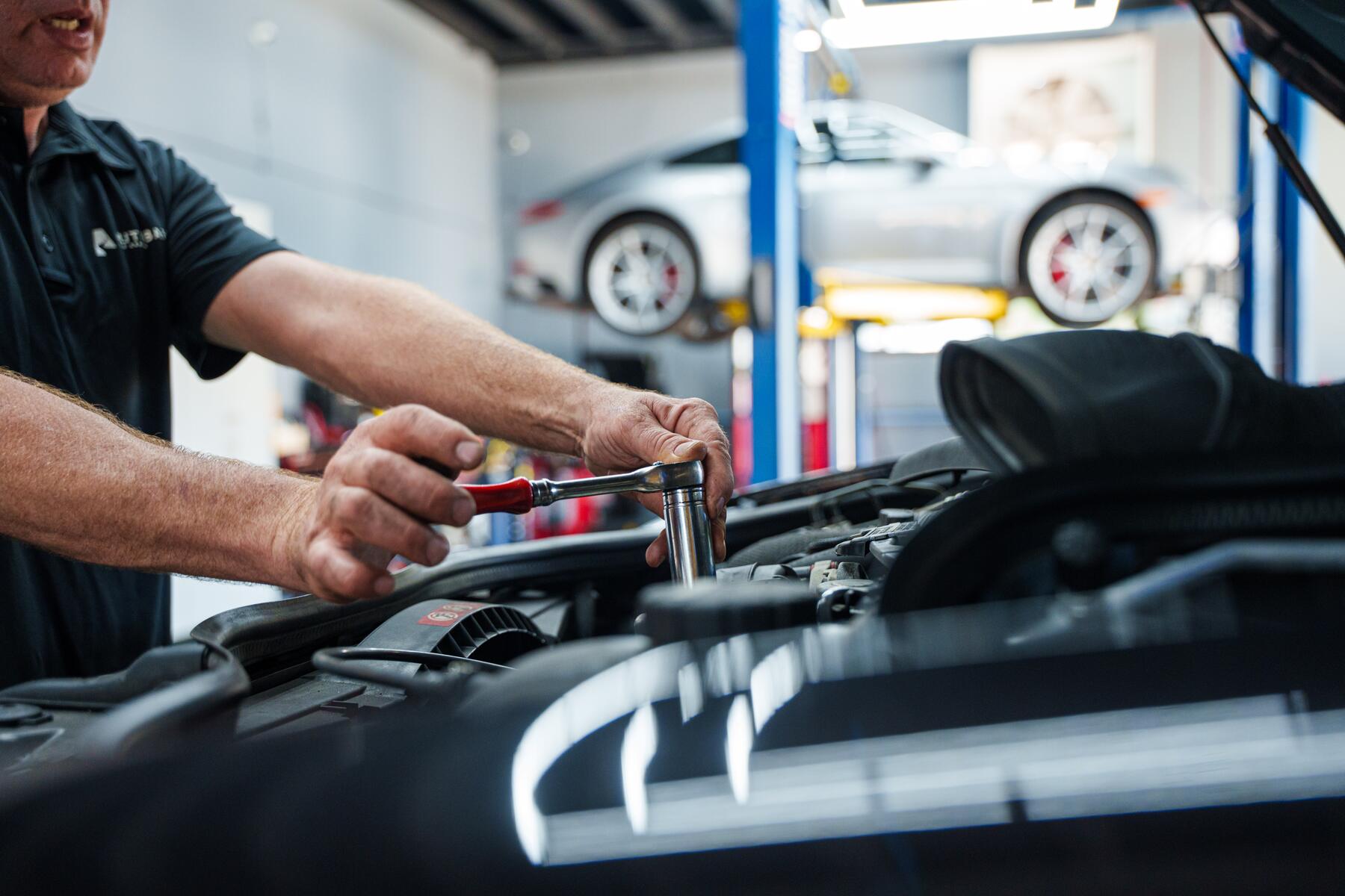 A torque wrench being used on a vehicle at Autobahn Auto Center