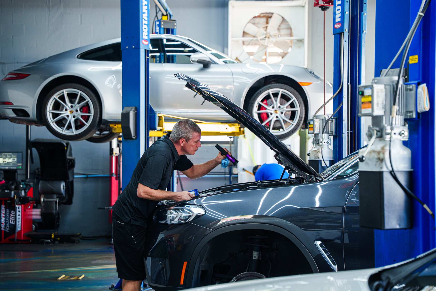 An Autobahn technician working under the hood in the Boca Raton bay