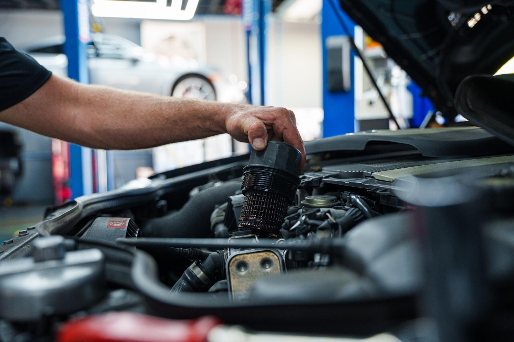 An Autobahn technician working in the engine bay in Boca Raton
