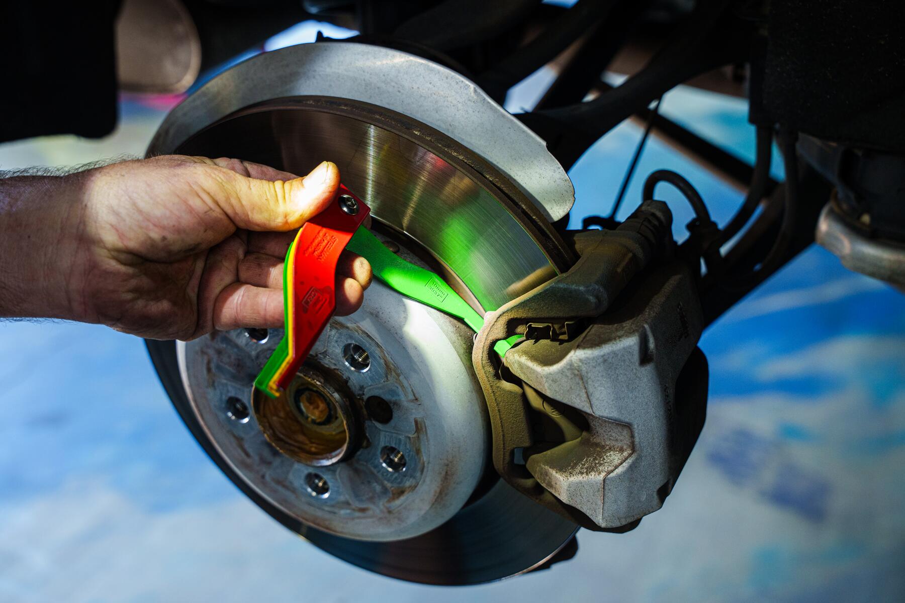 A brake rotor being measured during a digital inspection at Autobahn Auto Center