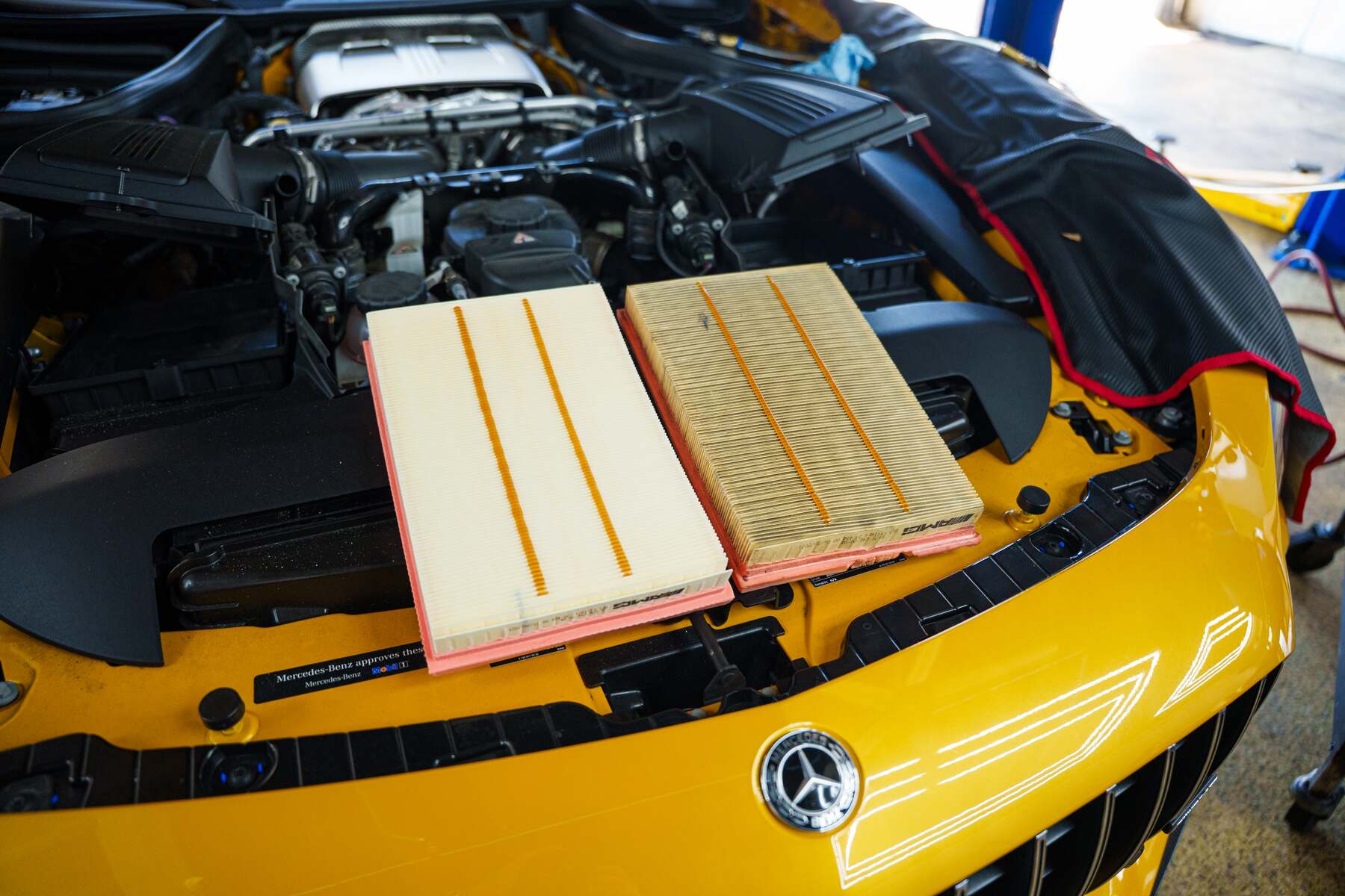 New air filters laid out on a Mercedes-AMG GT during a service